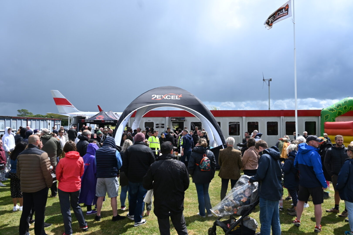 People gathered outside with flag at families day