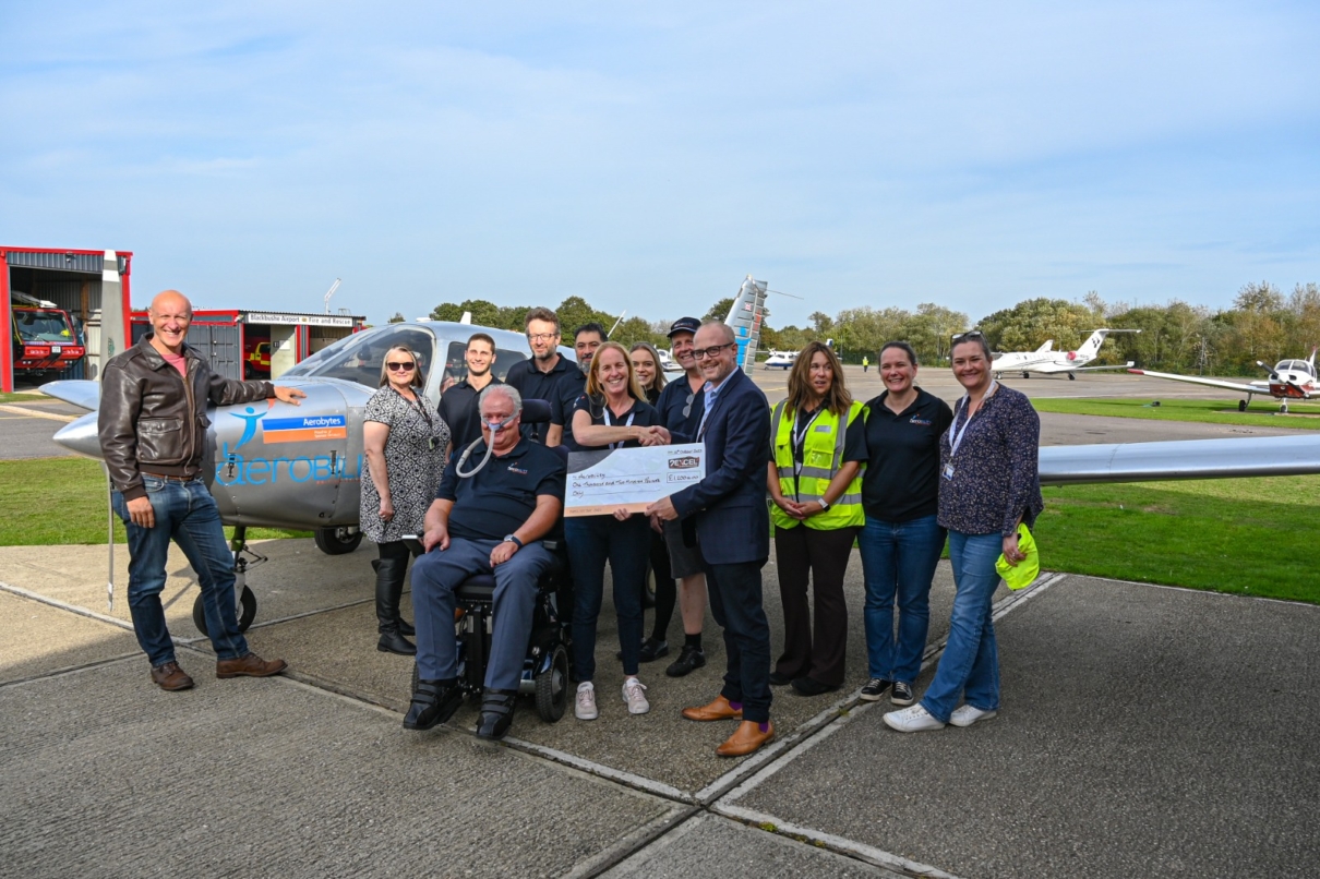 group of people in front of small aircraft